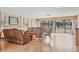 Relaxing living room features a fireplace, wood floors, and sliding glass doors leading to the outdoor area at 210 Santa Maria St # 244, Venice, FL 34285