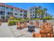 Comfortable outdoor seating surrounds a fire pit, perfect for relaxing and enjoying the community atmosphere at 210 Santa Maria St # 244, Venice, FL 34285