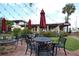 Inviting outdoor patio with elegant tables, chairs, umbrellas and a fountain at 210 Santa Maria St # 244, Venice, FL 34285