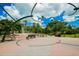 Beautiful park with open space, decorative water feature, picnic tables, and lush greenery at 210 Santa Maria St # 244, Venice, FL 34285