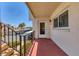 Private condo patio with railings and view of carports, and landscaping at 210 Santa Maria St # 244, Venice, FL 34285