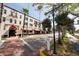 Attractive street view of a well-maintained building with hanging plants and palm trees at 210 Santa Maria St # 244, Venice, FL 34285