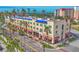 Stunning street view of the Historic Building with mature palm trees and ground floor retail at 210 Santa Maria St # 244, Venice, FL 34285