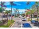 Picturesque street view with lush palm trees and attractive buildings creating a vibrant, walkable neighborhood at 210 Santa Maria St # 244, Venice, FL 34285