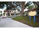Charming park view featuring a sign, lush greenery, and the corner of an inviting patio at 210 Santa Maria St # 244, Venice, FL 34285