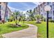 Scenic walkway weaves through lush landscaping offering a tranquil path between buildings at 210 Santa Maria St # 244, Venice, FL 34285