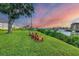 Picturesque waterfront view with Adirondack chairs on a manicured lawn overlooking the marina at 210 Santa Maria St # 244, Venice, FL 34285