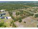 Aerial view of the property, showcasing the acreage with trees and ponds at 21616 67Th E Ave, Bradenton, FL 34211