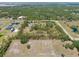 Expansive acreage featuring a private pond, verdant trees, and a well-maintained home with lots of potential at 21616 67Th E Ave, Bradenton, FL 34211