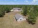 Aerial view of the property showing the main house, pool area, storage shed, and expansive tree-lined lot at 21616 67Th E Ave, Bradenton, FL 34211