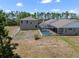 Backyard view showcasing the screened-in pool, fenced area, and the overall property layout under sunny skies at 21616 67Th E Ave, Bradenton, FL 34211