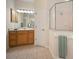 Bathroom featuring dual sinks, vanity area, walk-in shower, and tile flooring at 21616 67Th E Ave, Bradenton, FL 34211
