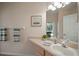 Well-lit bathroom featuring a spacious vanity, a decorative mirror and a glimpse of the pool area at 21616 67Th E Ave, Bradenton, FL 34211