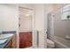 A bathroom is shown with shower, toilet, sink and vanity; a doorway leads to the bedroom at 21616 67Th E Ave, Bradenton, FL 34211