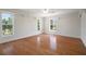 Bedroom with wood floors and view of the landscape through large windows at 21616 67Th E Ave, Bradenton, FL 34211
