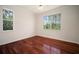 A bedroom features hardwood floors and two windows with lots of natural light at 21616 67Th E Ave, Bradenton, FL 34211
