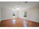 Bedroom featuring wood floors and two windows with views of the landscape at 21616 67Th E Ave, Bradenton, FL 34211