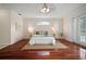 Bright bedroom with rich hardwood floors, neutral walls, and a double window providing natural light at 21616 67Th E Ave, Bradenton, FL 34211