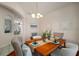 Cozy dining room featuring hardwood floors, decorative wall art, and views to the living area at 21616 67Th E Ave, Bradenton, FL 34211