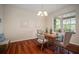 Charming dining room with hardwood floors, natural lighting, and an elegant chandelier at 21616 67Th E Ave, Bradenton, FL 34211