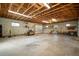 Large garage interior with overhead lighting, exposed ceiling, and concrete floors at 21616 67Th E Ave, Bradenton, FL 34211