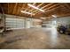 Spacious garage interior featuring concrete floors, block wall and exposed wood ceiling at 21616 67Th E Ave, Bradenton, FL 34211
