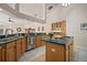 Expansive kitchen featuring natural wood cabinetry, stainless appliances, and tile floors at 21616 67Th E Ave, Bradenton, FL 34211