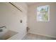 Light and airy laundry room with a window, sink, and storage shelves at 21616 67Th E Ave, Bradenton, FL 34211