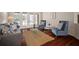 Bright living room featuring hardwood floors, french doors, and stylish blue velvet accent chairs at 21616 67Th E Ave, Bradenton, FL 34211