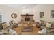 Spacious living room with brick fireplace, comfortable seating, and ample natural light at 21616 67Th E Ave, Bradenton, FL 34211