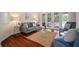 Comfortable living room featuring hardwood floors, stylish seating, and double doors leading to an outdoor pool at 21616 67Th E Ave, Bradenton, FL 34211