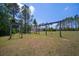 Backyard wooden playground with multiple swings, ready for fun at 21616 67Th E Ave, Bradenton, FL 34211