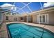 Screened pool area boasts brick pavers, comfortable seating, and easy access to the home's interior at 21616 67Th E Ave, Bradenton, FL 34211