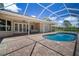 Screened pool area with brick pavers, outdoor furniture, and easy access to the home's interior at 21616 67Th E Ave, Bradenton, FL 34211