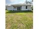 Backyard view of the house with a covered patio and sliding glass doors at 2163 Blaser St, Port Charlotte, FL 33980