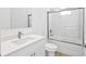 Modern bathroom featuring a sleek vanity, toilet, and shower-tub combination with glass doors at 2163 Blaser St, Port Charlotte, FL 33980