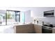 Contemporary kitchen featuring marble countertops, wooden cabinets, and stainless-steel appliances at 2170 Robinhood St # A1-302, Sarasota, FL 34231