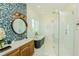 Bright bathroom featuring a glass shower, soaking tub, and vanity with custom backsplash at 221 Grant Dr, Sarasota, FL 34236