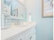 Bright bathroom with white vanity, framed mirror, and coastal decor at 221 Grant Dr, Sarasota, FL 34236