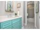 Bathroom with turquoise vanity and patterned floor tiles at 221 Grant Dr, Sarasota, FL 34236