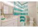 Bathroom with geometric tile in shower, a glass shower door, and modern fixtures at 221 Grant Dr, Sarasota, FL 34236