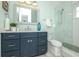 Bathroom featuring a shower, vanity, and ocean-themed accents at 221 Grant Dr, Sarasota, FL 34236
