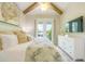 Bedroom with a decorative pillows, white furniture, and access to an outdoor balcony at 221 Grant Dr, Sarasota, FL 34236