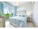 Light-filled bedroom with a spiral staircase, white walls, and a private balcony at 221 Grant Dr, Sarasota, FL 34236