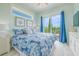 Bright bedroom featuring stylish decor and a private balcony with bright blue curtains at 221 Grant Dr, Sarasota, FL 34236