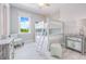 Well-lit bedroom features a bunk bed, light wood floors, and calming gray walls at 221 Grant Dr, Sarasota, FL 34236