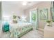 Bedroom with a light comforter, white furniture, and coastal decorations at 221 Grant Dr, Sarasota, FL 34236