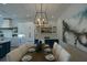 Elegant dining room with modern lighting and seating for eight, open to kitchen and living area at 221 Grant Dr, Sarasota, FL 34236