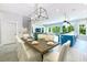 Elegant dining room with modern lighting and seating for eight, open to kitchen and living area at 221 Grant Dr, Sarasota, FL 34236