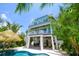 Three story home with a pool, covered seating, and spiral staircases surrounded by palm trees at 221 Grant Dr, Sarasota, FL 34236